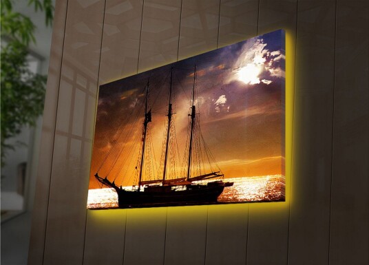 Lerretsbilde med LED belysning 45x70 cm Seilbåt mot en solnedgang over havet Oransje / Svart / Gull
