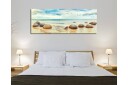 Lerretsbilde 80x30 cm Runde steiner på en strand med hav og himmel i bakgrunnen Blå / Beige / Grå