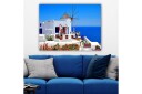 Lerretsbilde 70x100 cMalerisk utsikt over en hvitkalket bygning med en tradisjonell vindmølle og fargerike blomster på Santorini Hvit / Blå / Rød
