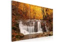 Bilde A waterfall in the middle of fall trees 90x60 Artgeist sp. z o. o.
