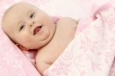 Babyteppe med barnets navn på en eng.