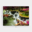 Lerretsbilde 70x100 cm Vakker foss omgitt av fargerike blomster og frodige trær Grønn / Rosa / Brun